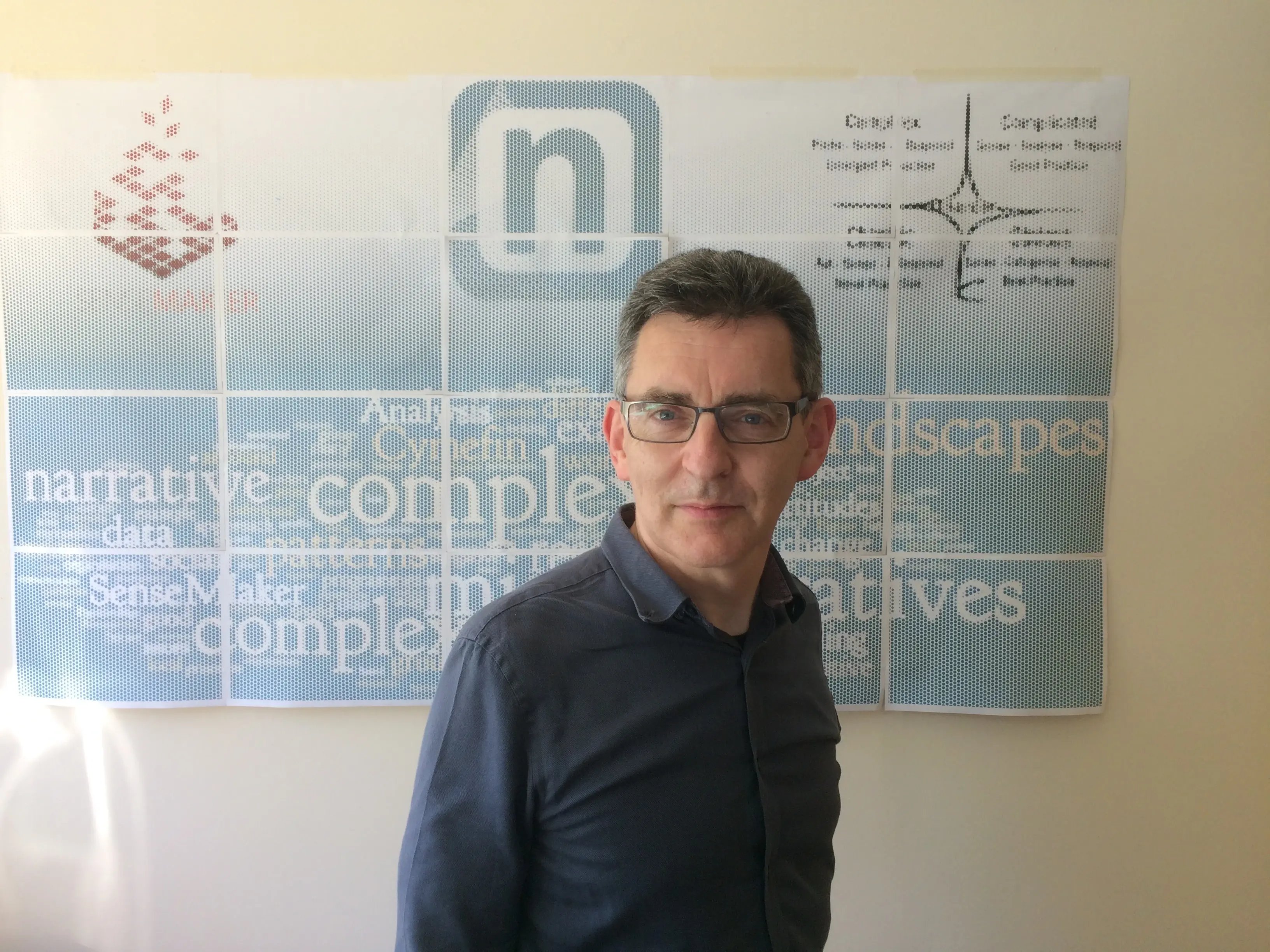 Tony Quinlan, board advisor and complexity specialist, with a backdrop referencing the Cynefin framework, narrative research, and SenseMaker methodology.