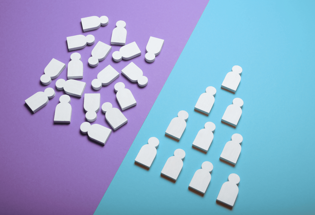 White wooden figures scattered on a purple background next to an organised pyramid on blue, symbolising the shift from confusion to clarity in teams working through chaos.