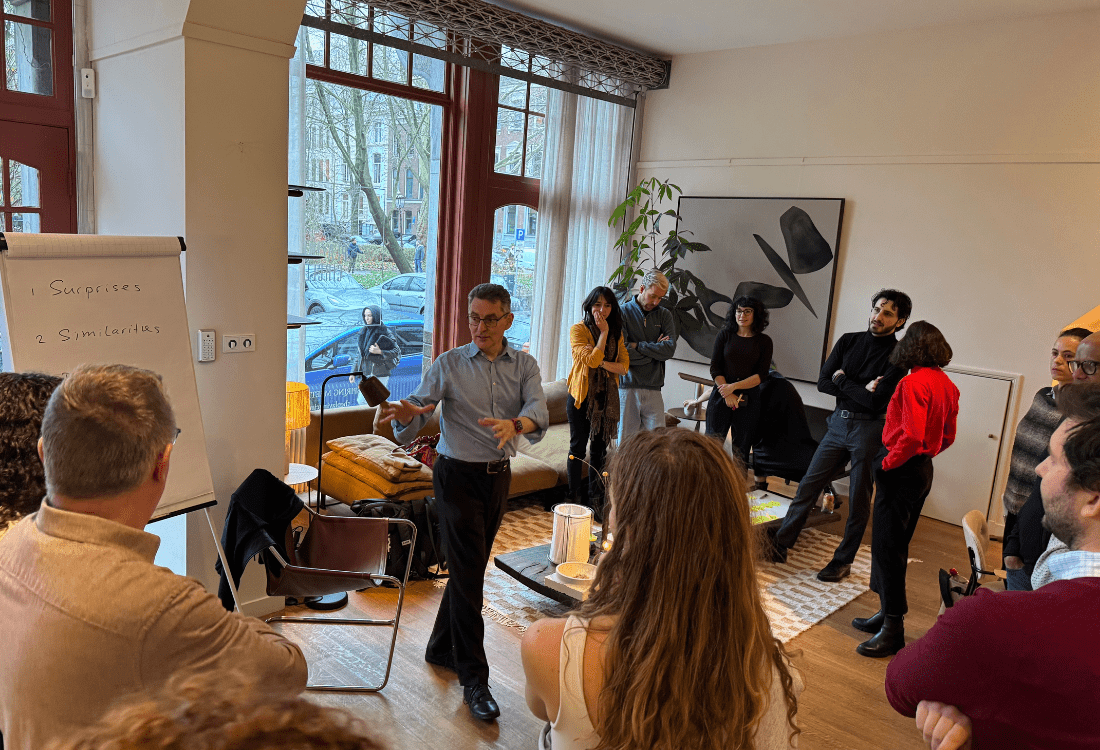 A facilitator leads a group workshop where employees stand in discussion circles, exploring differences and similarities as part of a team-building and organisational change exercise.